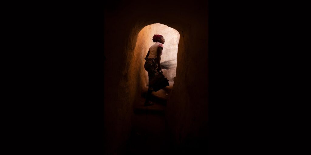 A woman walking up to the building’s flat rooftop, Bobo-Dioulasso, credit: Iwan Baan, 2021.