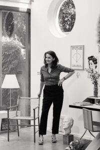 Nicole Ex in her home, with a work by David Shrigley in the background and a hand-made chair by Bijoy Jain of Studio Mumbai (guest curator of See All This #32) | photo: Sanja Marušić