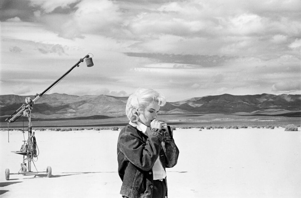 Marilyn Monroe on the Nevada desert going over her lines for a difficult scene she is about to play with Clark Gable in the film The Misfits, 1960